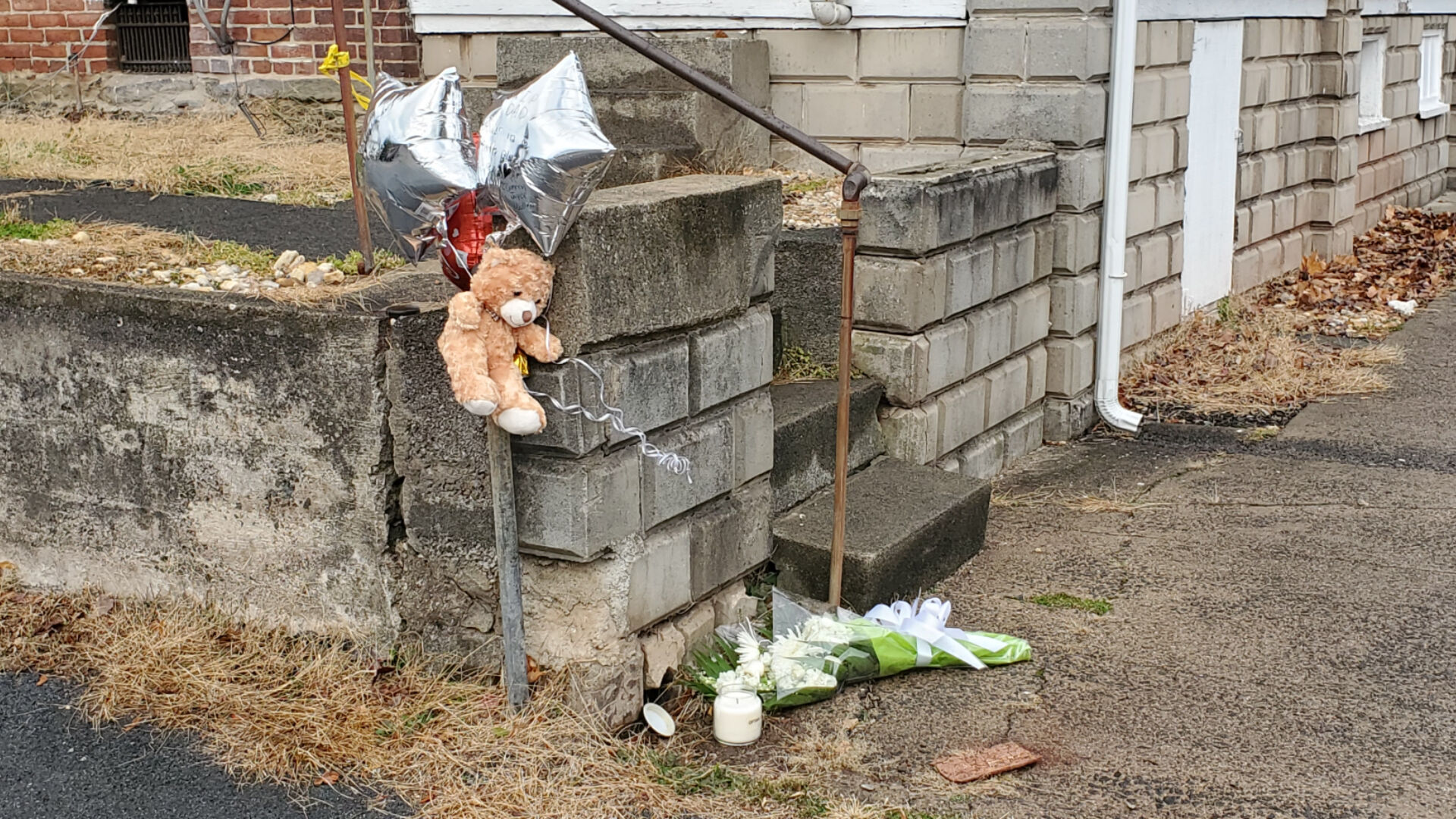 Balloons and toys lay on the sidewalk in honor of Pottstown shooting victim